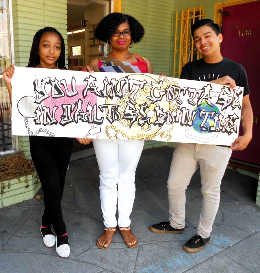 Young artists Alasia Ayler, Brianna Pierce and Vernon Neely display their artistic statement: “You ain't gotta be in jail to be doing time.” Lydia Gans photo