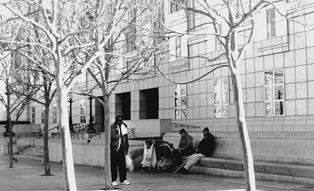 Homeless people sit outside the San Francisco Public Library. Lydia Gans photo