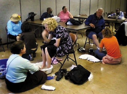 Volunteers at the Suitcase Clinic offer footwashing and many kinds of free health care to homeless and low-income persons.