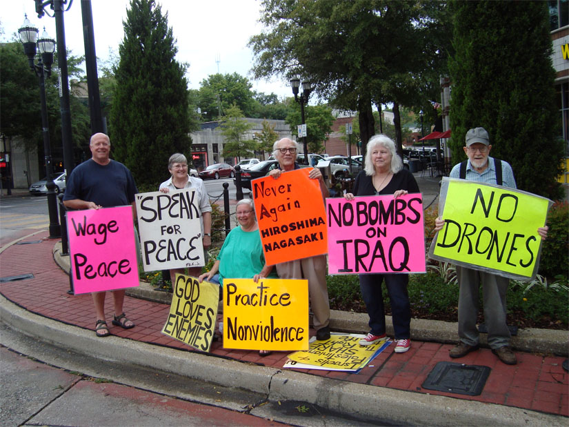 Jim and Shelley Douglass hold a protest in Birmingham, Alabama, of U.S. drones and bombing raids on Iraq.