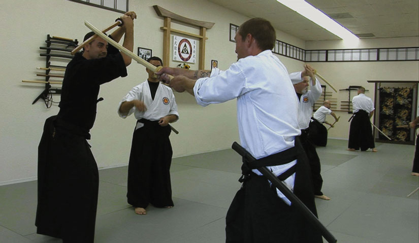 Jason Witt (at right, in white) undergoes martial arts training at the Contra Costa Budokan Martial Arts Academy.