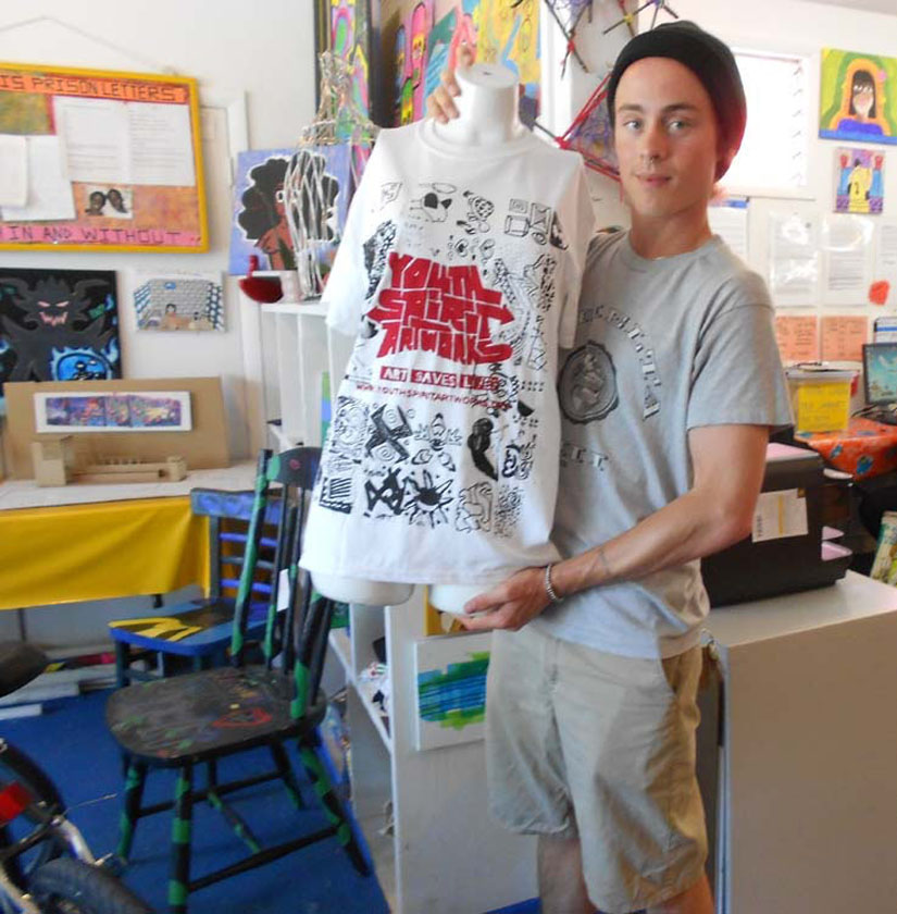 Brandon Pritzkat displays a t-shirt created by young artists to sell on the streets of Berkeley.