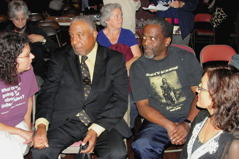Dr. Bernard Lafayette (center, in suit) discusses nonviolence with activists in Oakland. Lafayette was chosen by Martin Luther King to direct the Poor People’s Campaign in 1968, and now teaches Kingian Nonviolence. Photo by Howard Dyckoff