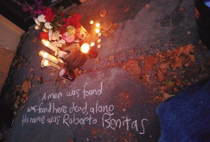 Flowers and candles were placed as a memorial on the sidewalk where a day laborer died in Berkeley. Written in chalk are the words: “A man was found here dead, alone. His name was Roberto Benitez.” Daniel McMullan photo