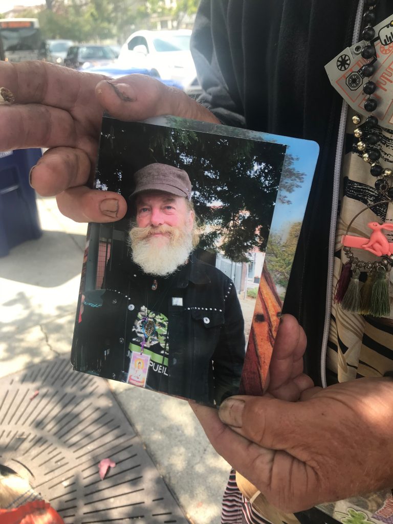 Douglas Freitag holds up a photo of himself.