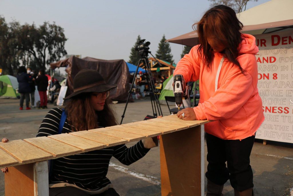 Volunteers help build structures for HDV residents to live in.