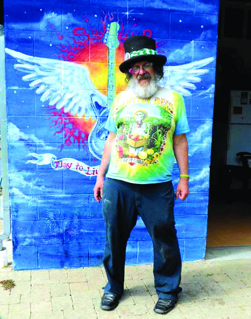 Michael Diehl poses in front of a mural in 2014.