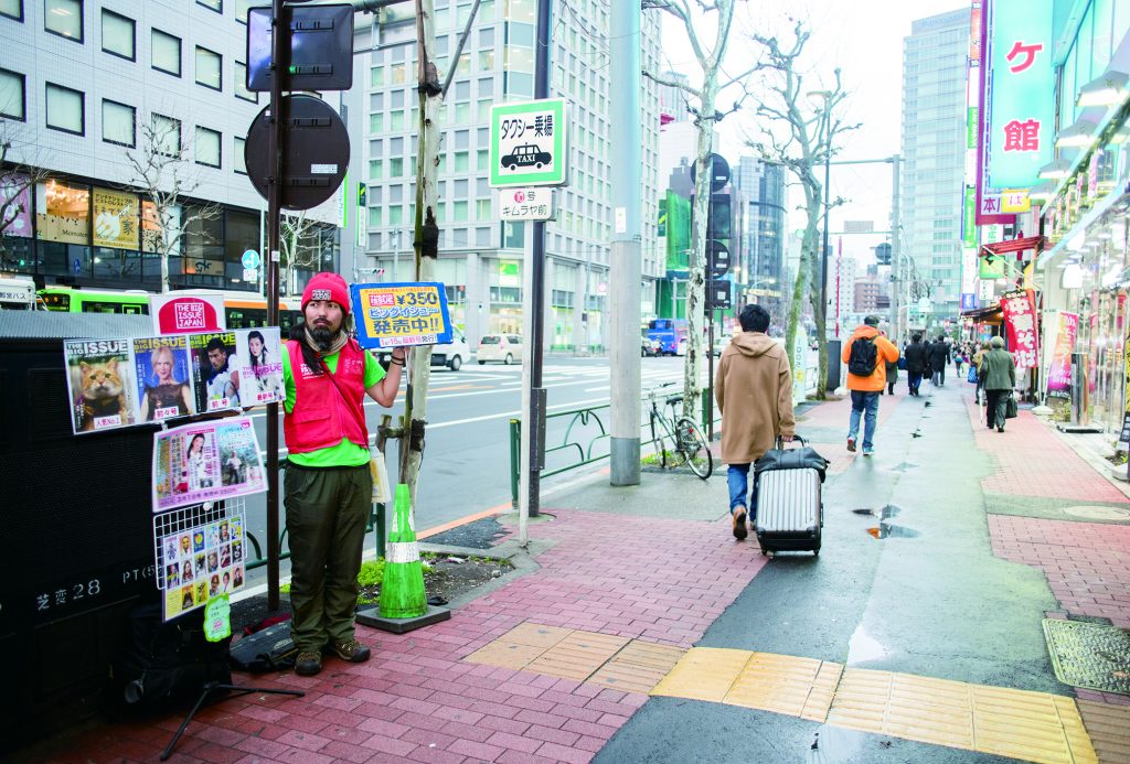 Nishi sells copies of The Big Issue in Toyko.