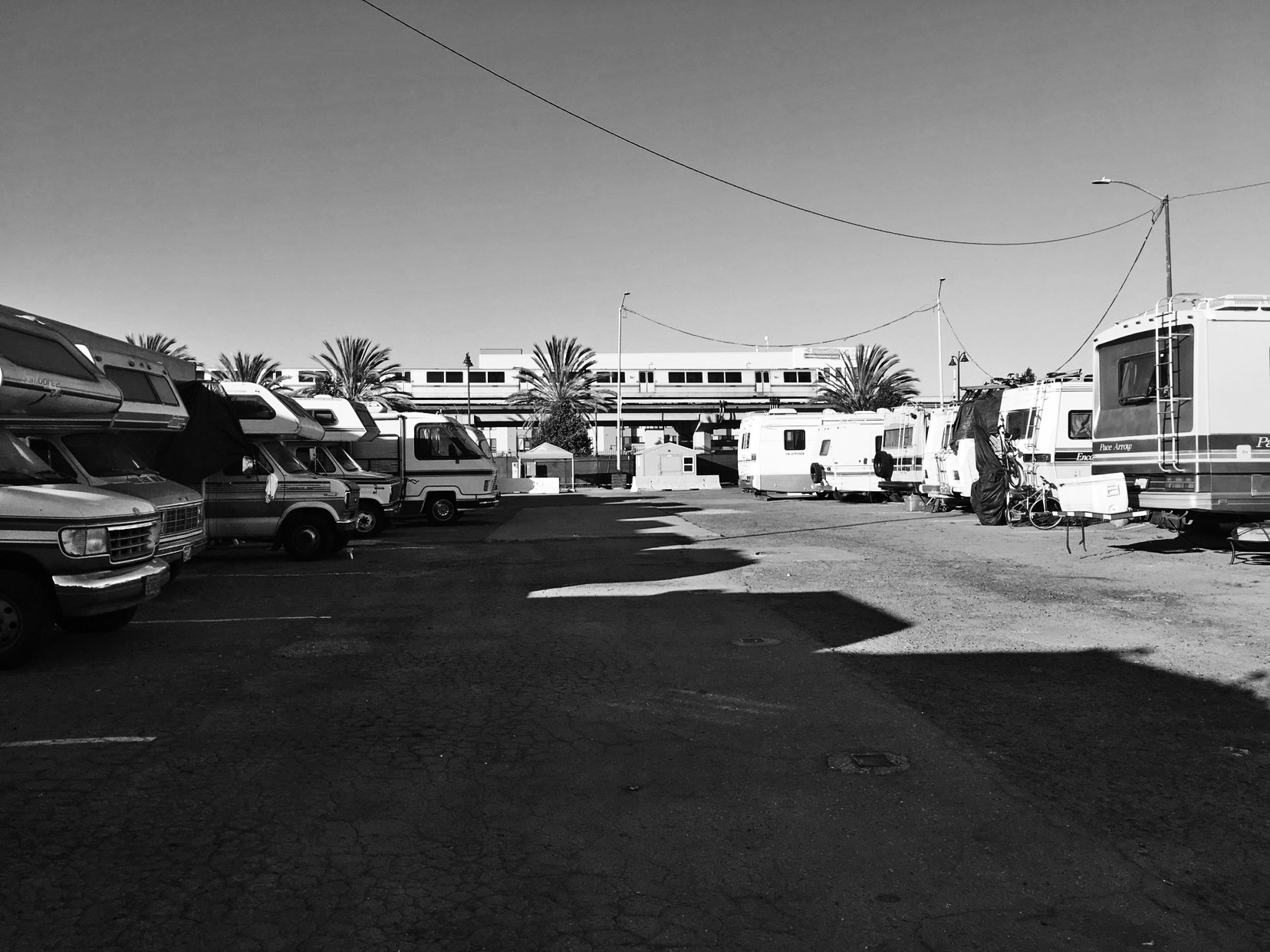 Black and white phono of an RV park cast in midday shadow