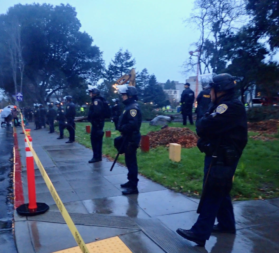 UC Police officers line up down Haste Street in front of People's Park while the tree cutting takes place.