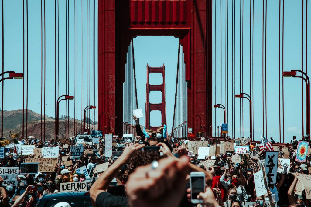 Protesters storm the golden gate bridge. Hundreds spill into the roadway and halt traffic on the Golden Gate Bridge. 