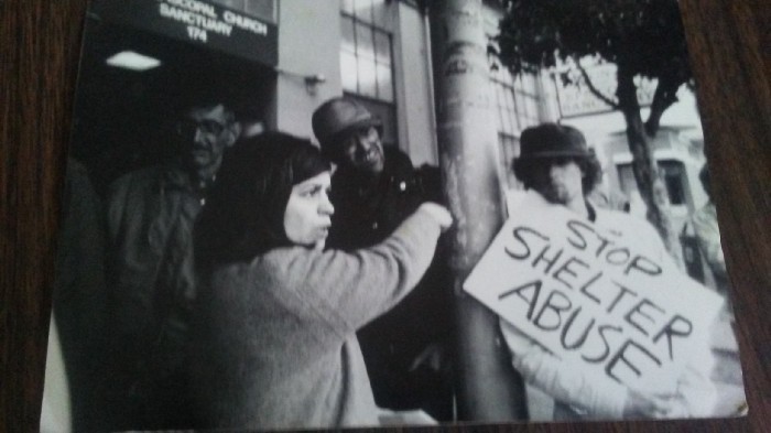 Black and white photograph of a Homeless Union Protest in San Francisco sometime in the late 80s. Sarah Menefee is front center left. Mike Lee is not in the photo.