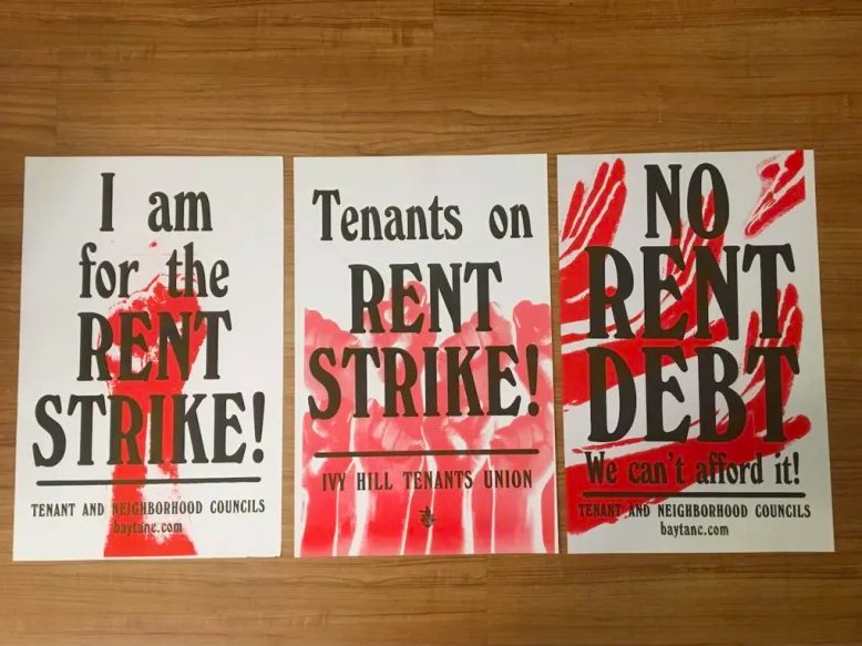 Three red and black posters that say "I am for the rent strike!"' "tenants on rent strike!"; and "no rent debt we can't afford it!"