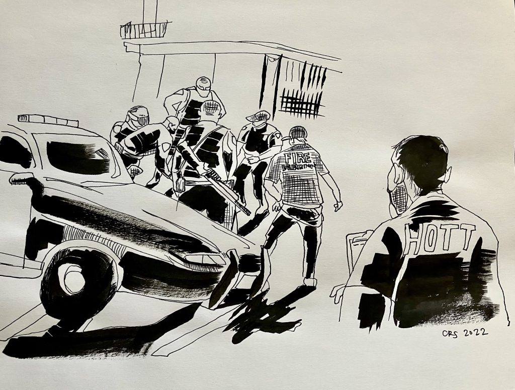 A black and white illustration of a bunch of cops and a police car surrounding someone on the sidewalk while a volunteer watches and documents.
