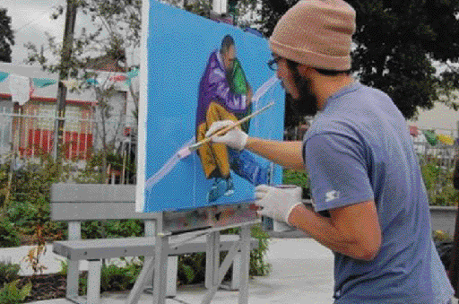 During St. Mary’s vigil for homeless people who died in the past year, Dave Kim, an artist with the Community Rejuvenation Project, painted a portrait of a homeless man holding and comforting another person on the streets. Mina Gaskell Photo