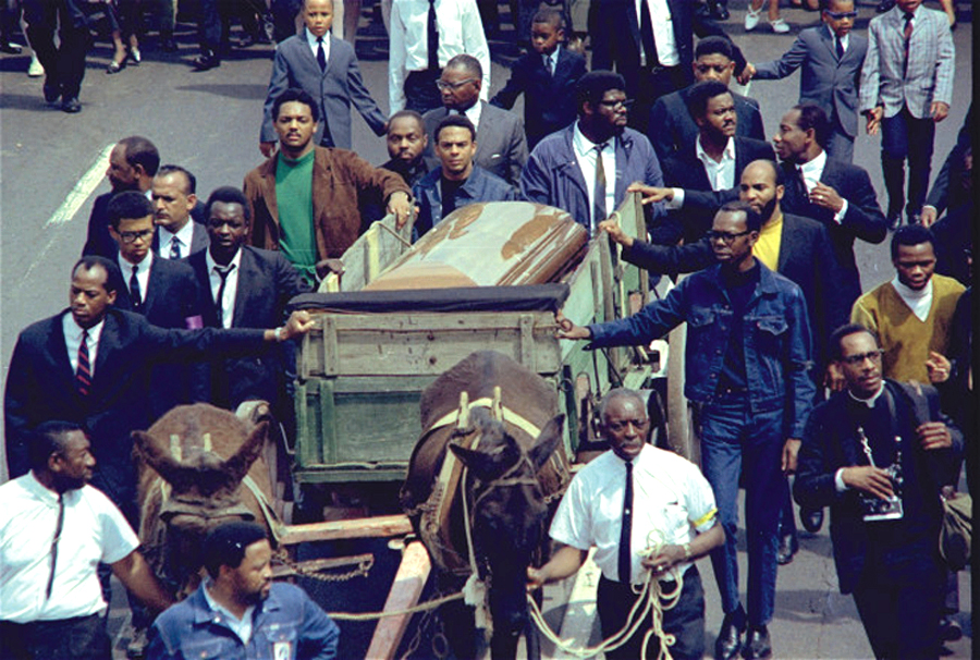 Two plow mules draw the farm wagon bearing the casket of Rev. Martin Luther King, Jr. along the funeral procession route in Atlanta, Georgia, April 9, 1968.