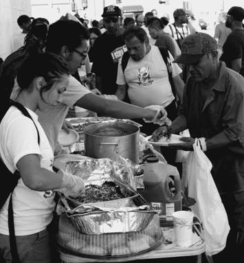 Food Not Bombs in Los Angeles provides a free meal, as part of a picnic on Skid Row to defend the right to share food. Photo by Dan Bluemel LA Activist