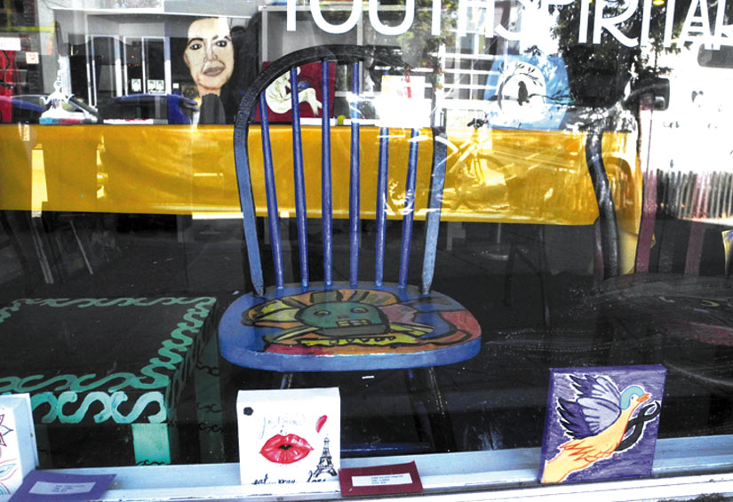 A painted chair in the front window of Youth Spirit Artworks. Carol Denney photo