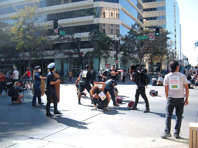 Theater groups occupied street intersections in downtown Oakland in protest of Urban Shield exercises and police repression.