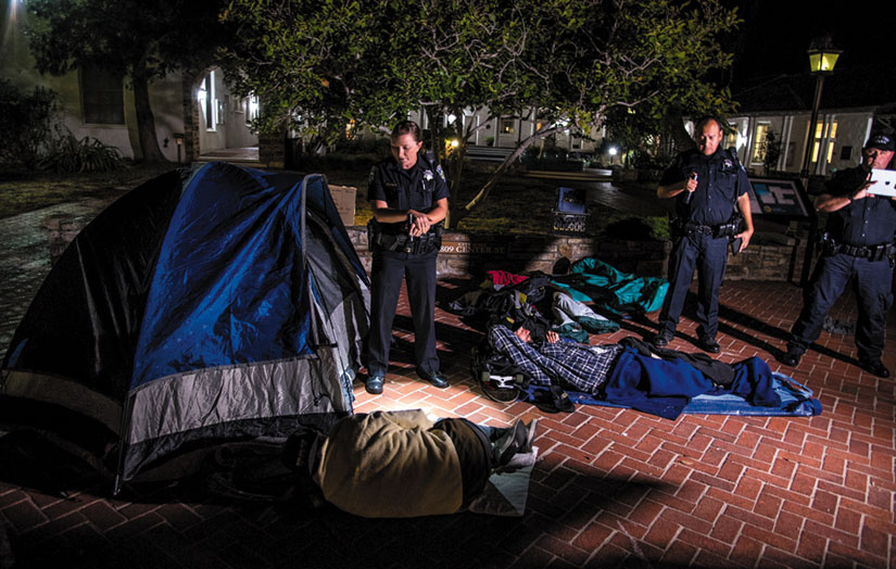 Santa Cruz police roust Freedom Sleepers during the sleep-out protests at Santa Cruz City Hall. Alex Darocy photo