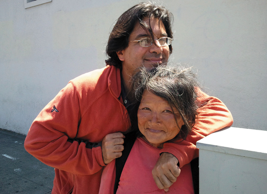 Amir Soltani, producer and co-director of Dogtown Redemption, hugs Miss Hayok Kay, a woman recycler who was featured in the film. Kay was well-loved by many friends, but ended up in the East Bay. She was killed in a brutal assault while living on the street.