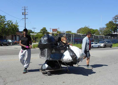Recyclers push heavy, overburdened carts down Oakland streets. Lydia Gans photos