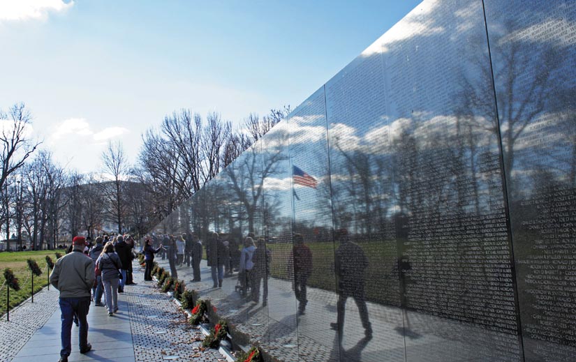 Images of visitors are reflected in the Vietnam Veterans Memorial Wall at the National Mall in Washington, D.C. Photo by Mario Roverto Duran Ortiz