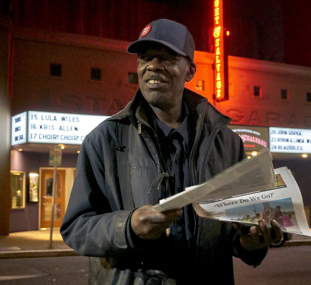 Ken Jones holds a pile of Street Spirit newspapers outside the Freight and Salvage in Downtown Berkeley.